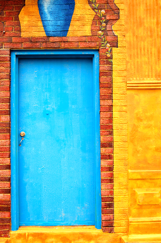 Yellow door in the Pilsen neighborhood of Chicago, Illinois - photographed by Justin Winget