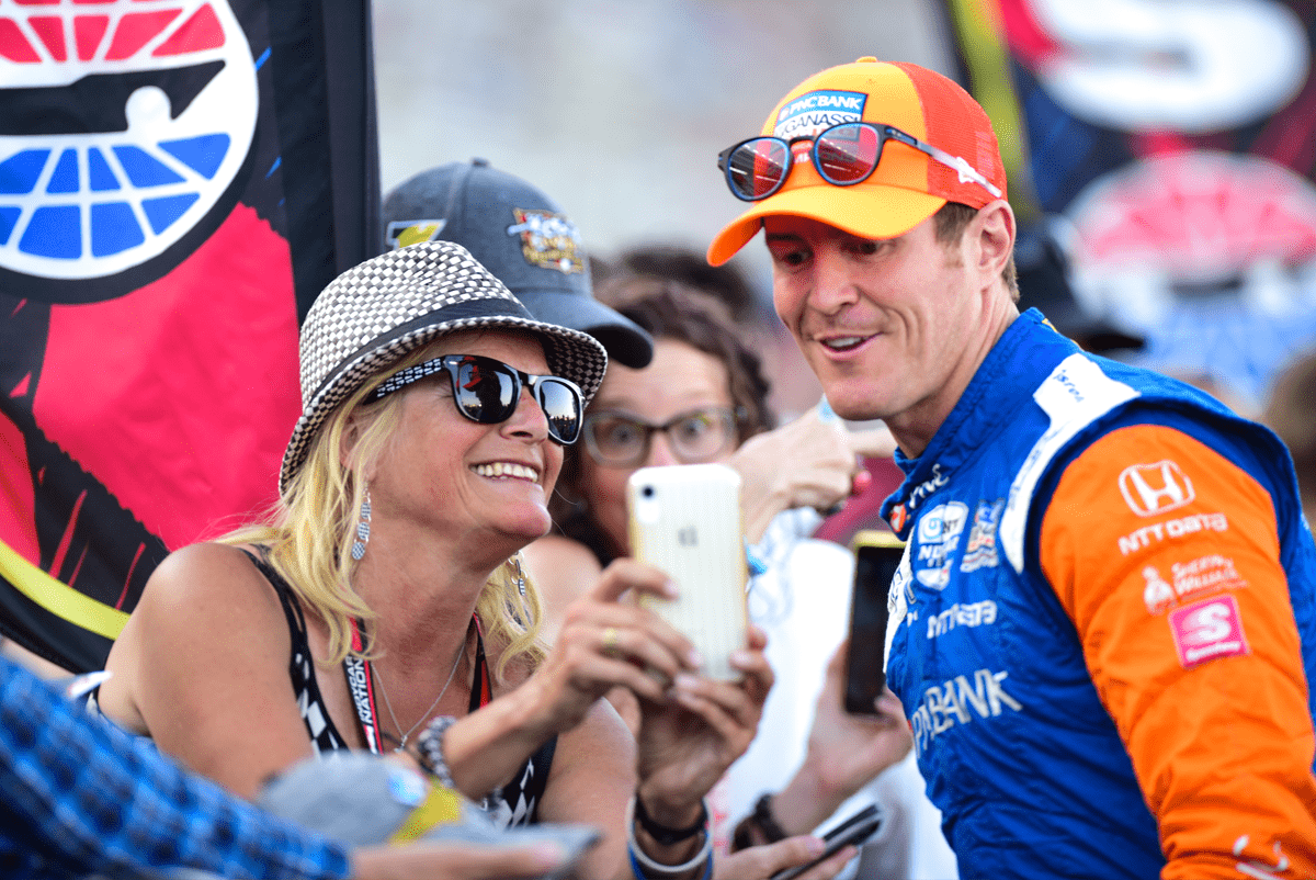 photo of IndyCar driver Scott Dixon with a fan at the Texas Motor Speedway by Justin Winget
