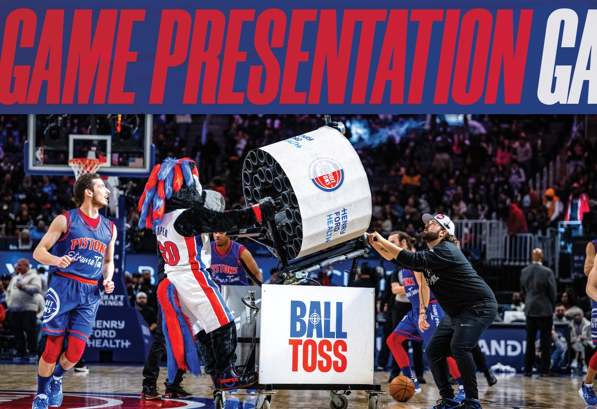 Detroit Pistons Mascot Hooper fires the Henry Ford Health T-shirt cannon at Little Caesars Arena - design by Creative Director Justin Winget